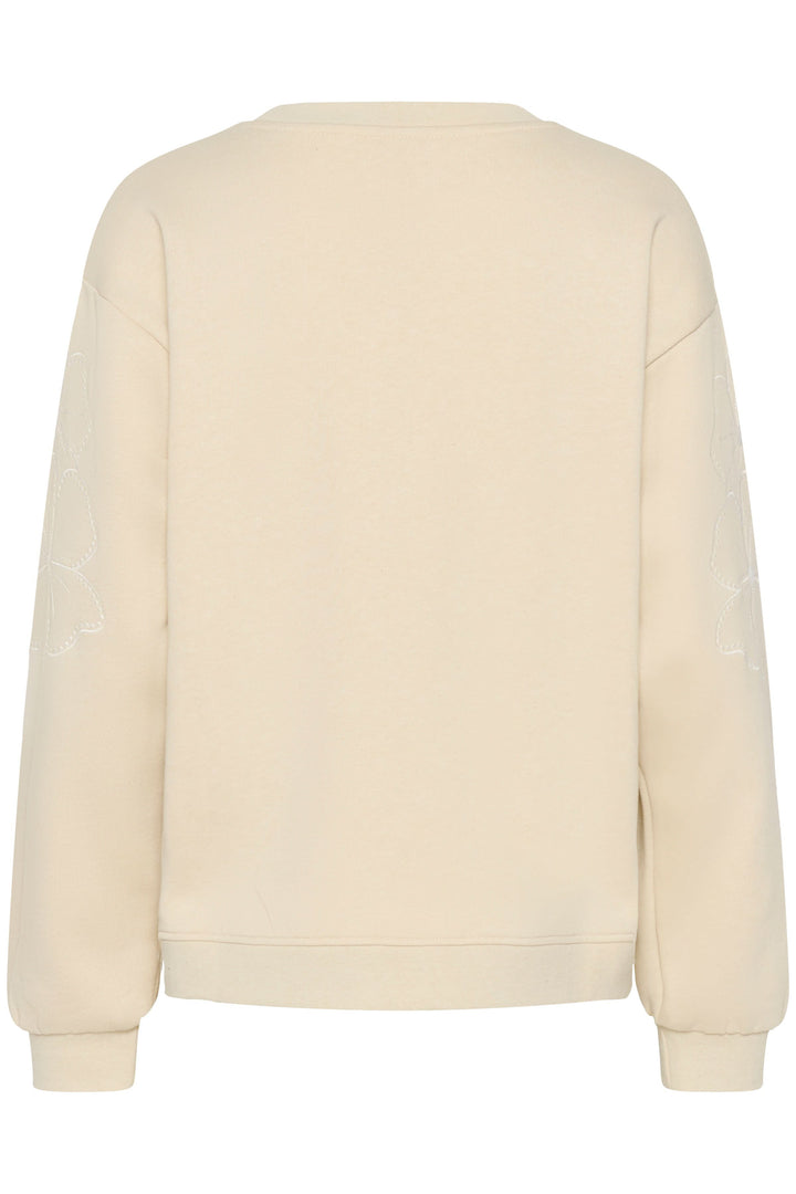 Vue arrière du coton ouaté Daria beige avec coupe droite et détails floraux discrets, matière moelleuse pour confort et style décontracté.
