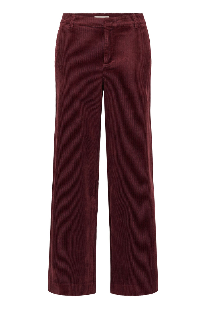 Pantalon Clarissi en velours côtelé bordeaux avec coupe large et taille haute pour un style rétro-chic et moderne.