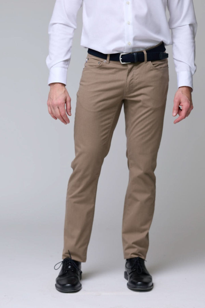 Homme portant un pantalon chino extensible coupe ajustée, idéal pour style bureau ou décontracté. Tissu doux, élégant et confortable.