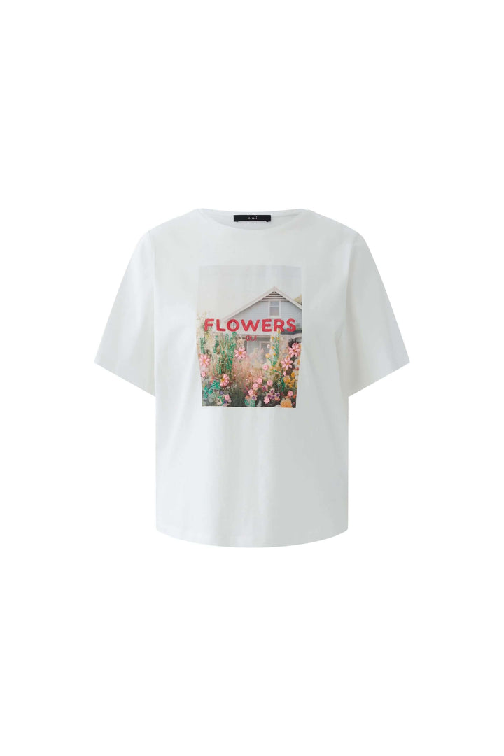 T-shirt imprimé graphique avec visuel floral sur fond blanc.