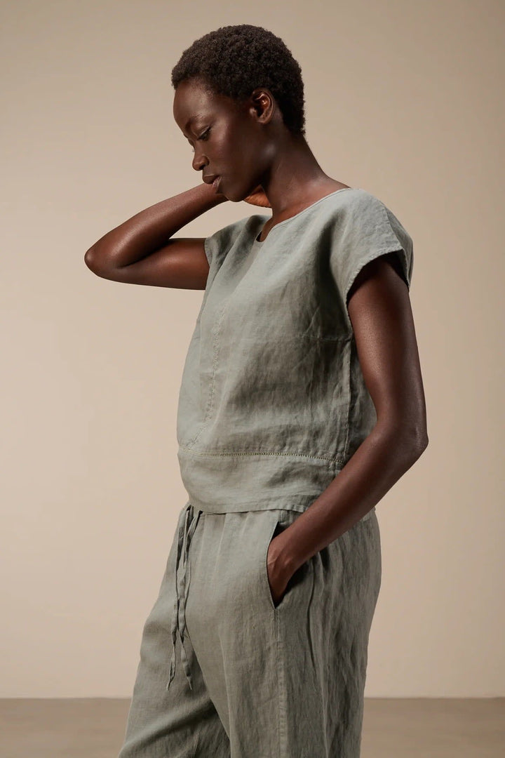 Side view of a beige linen blouse with embroidered details by Nile for women - Valérie Simon