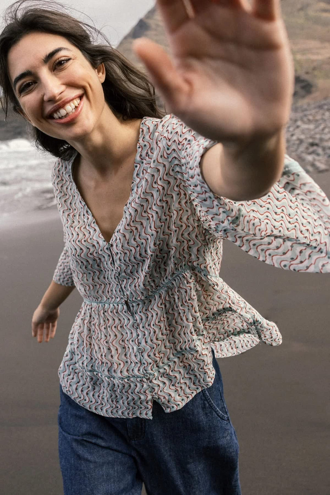 Front view of a collarless printed blouse for women colour in blue with a floral pattern - Valérie Simon