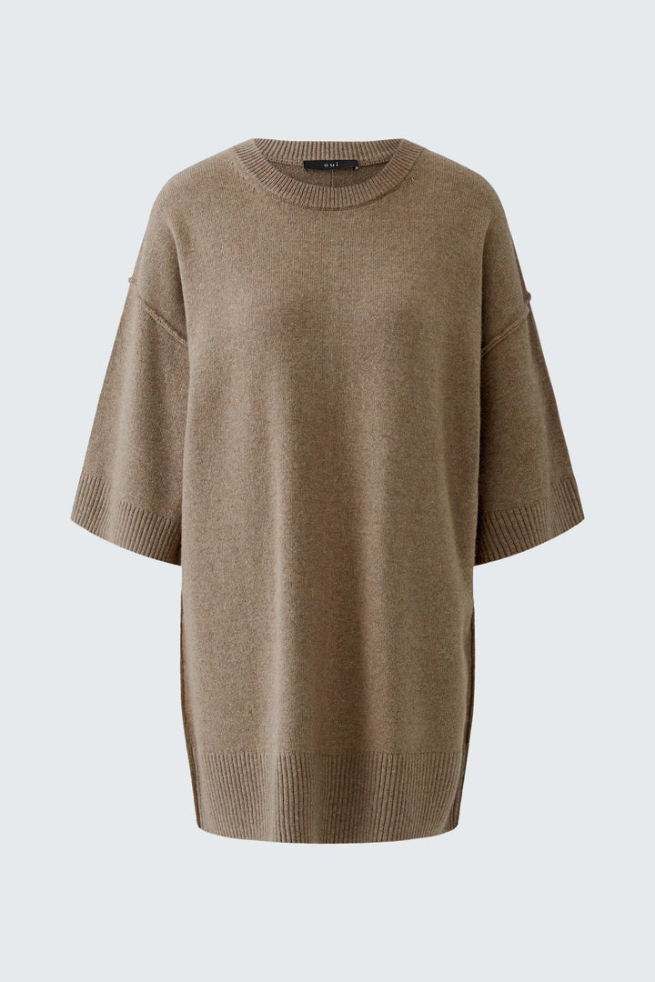 Model wearing the long wool sweater Oui for women in grey with a turtleneck and long sleeves - Valérie Simon