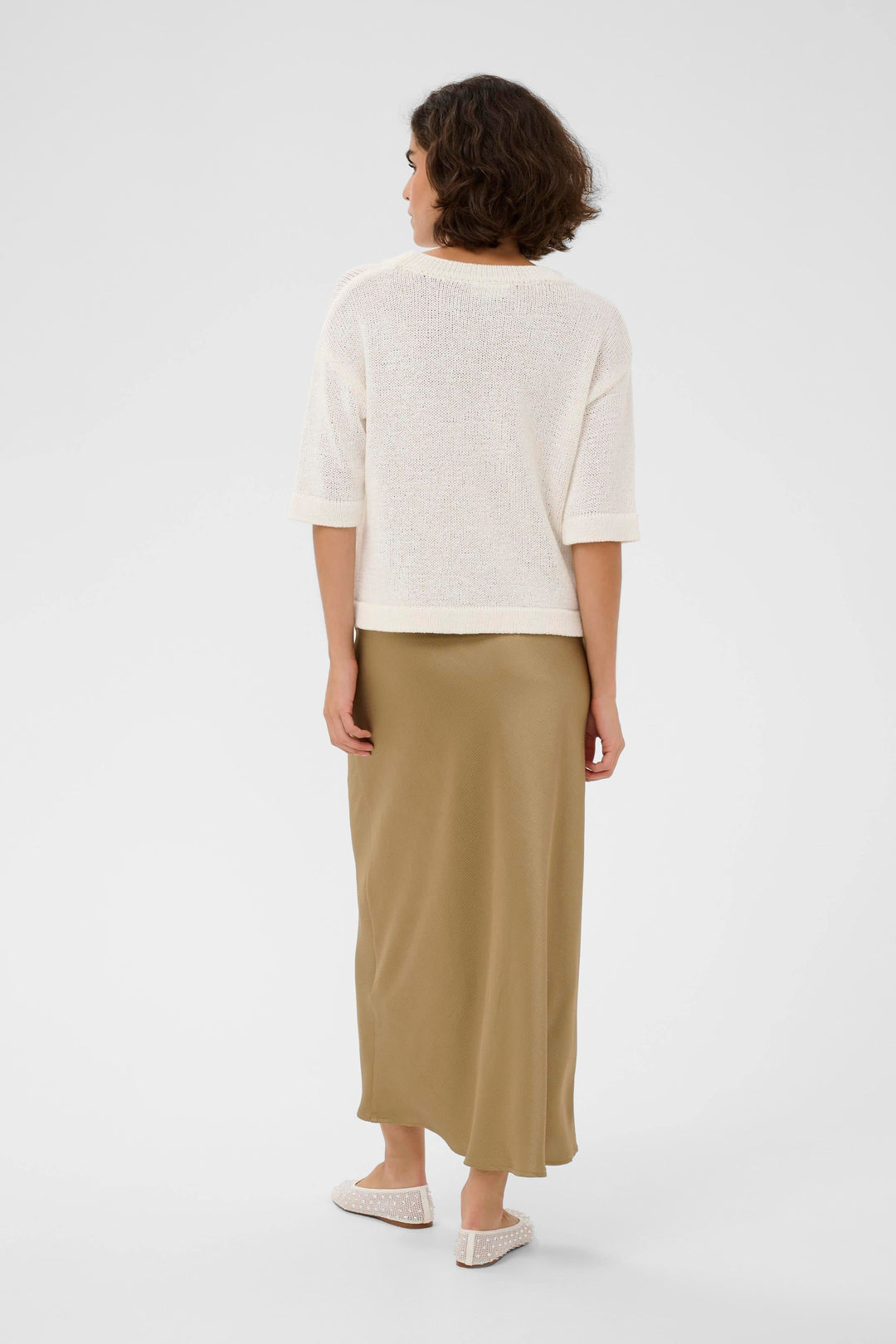 Side view of a long, flowing, textured beige Kaffe women&