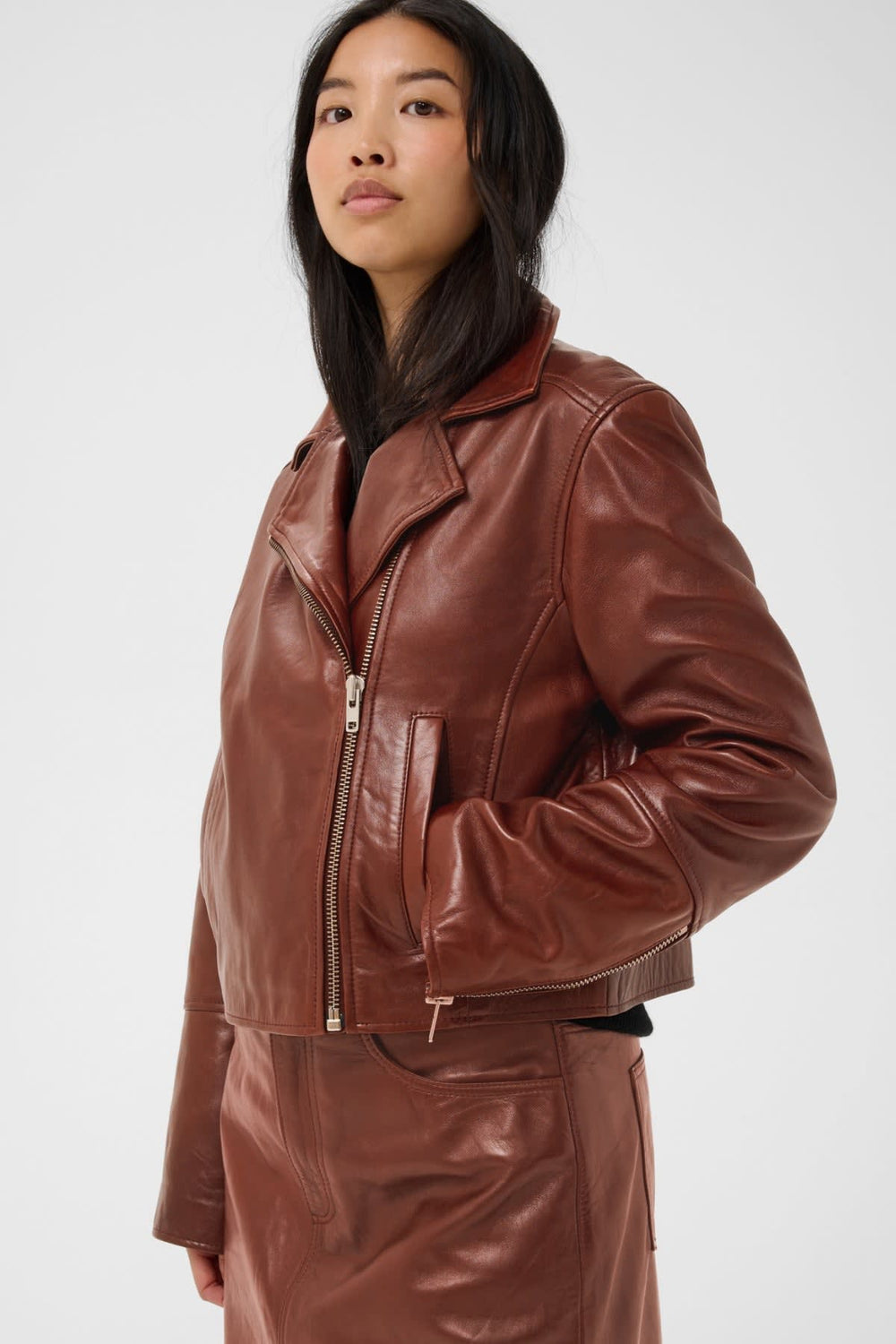 Women's black short leather jacket, front view Part Two