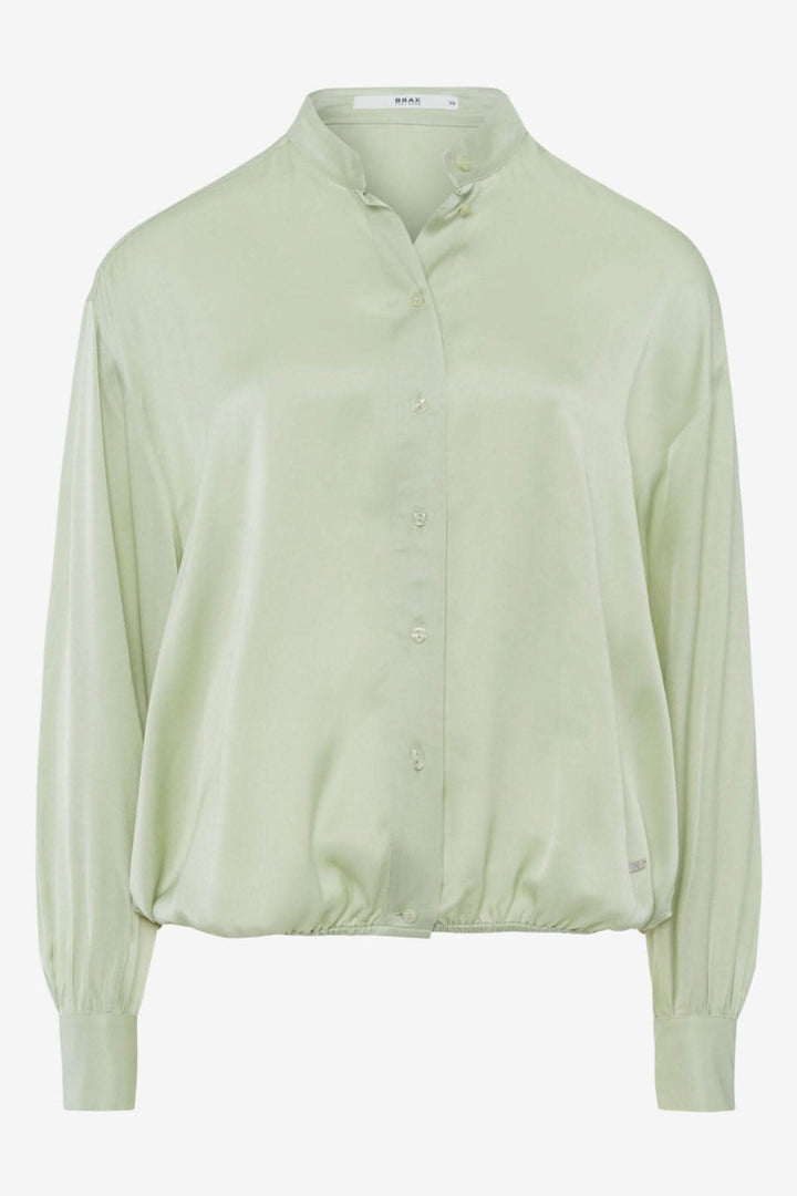 Blouse sans col en viscose confortable, manches bouffantes, coupe droite, couleur vert pâle.