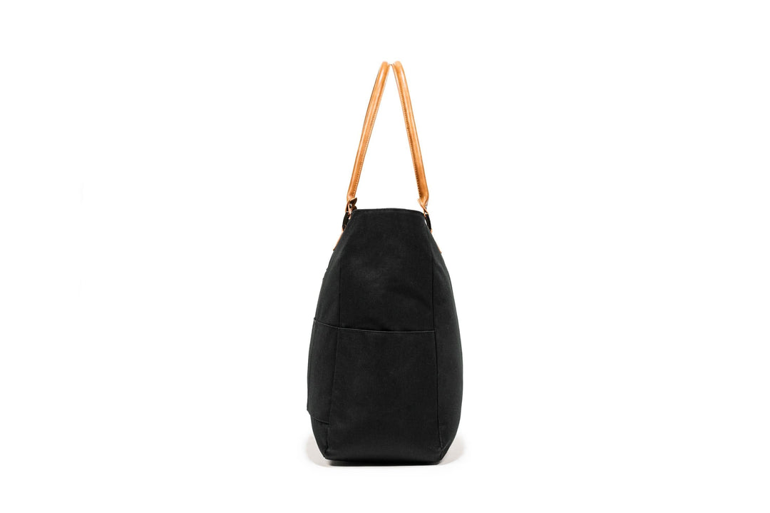 PKG Georgian recycled 33L tote bag with faux leather accents and padded base, ideal for travel and weekend trips.