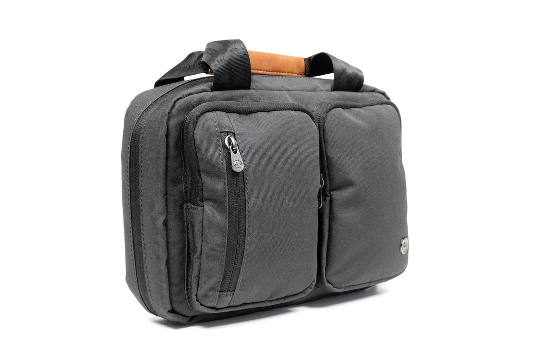 PKG Simcoe recycled essentials bag in gray with vegan leather accents and multiple compartments for toiletries.